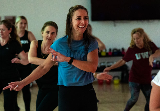 Fitness class with women exercising