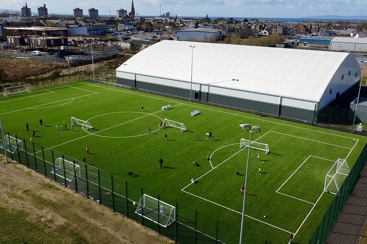 Playing football on sports pitch at The Circuit