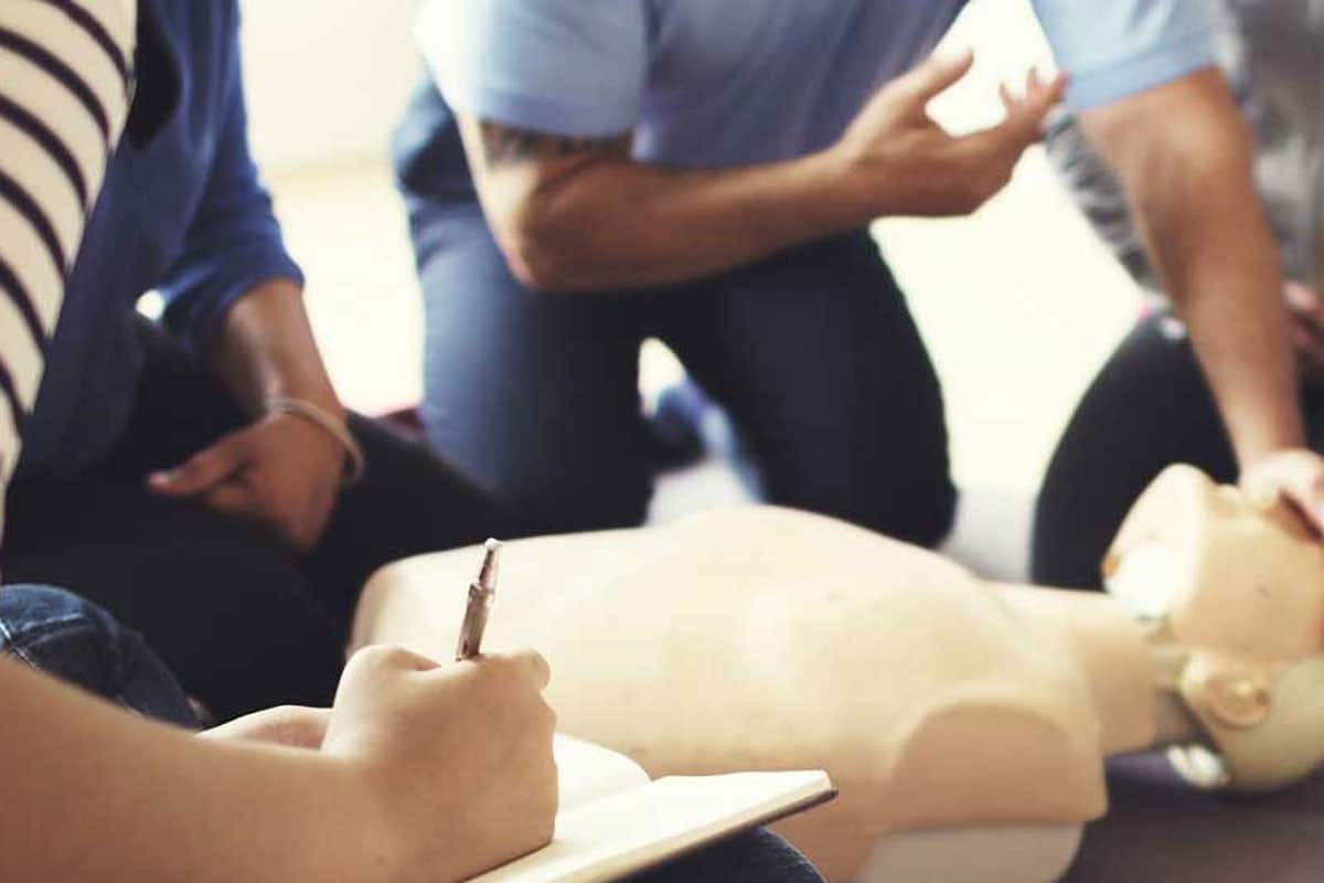 ana-first-aid Man teaching first aid on a medical dummy