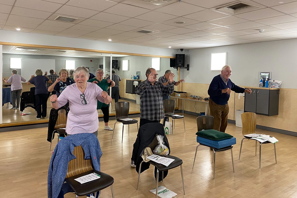 Participants in a falls prevention class doing exercises
