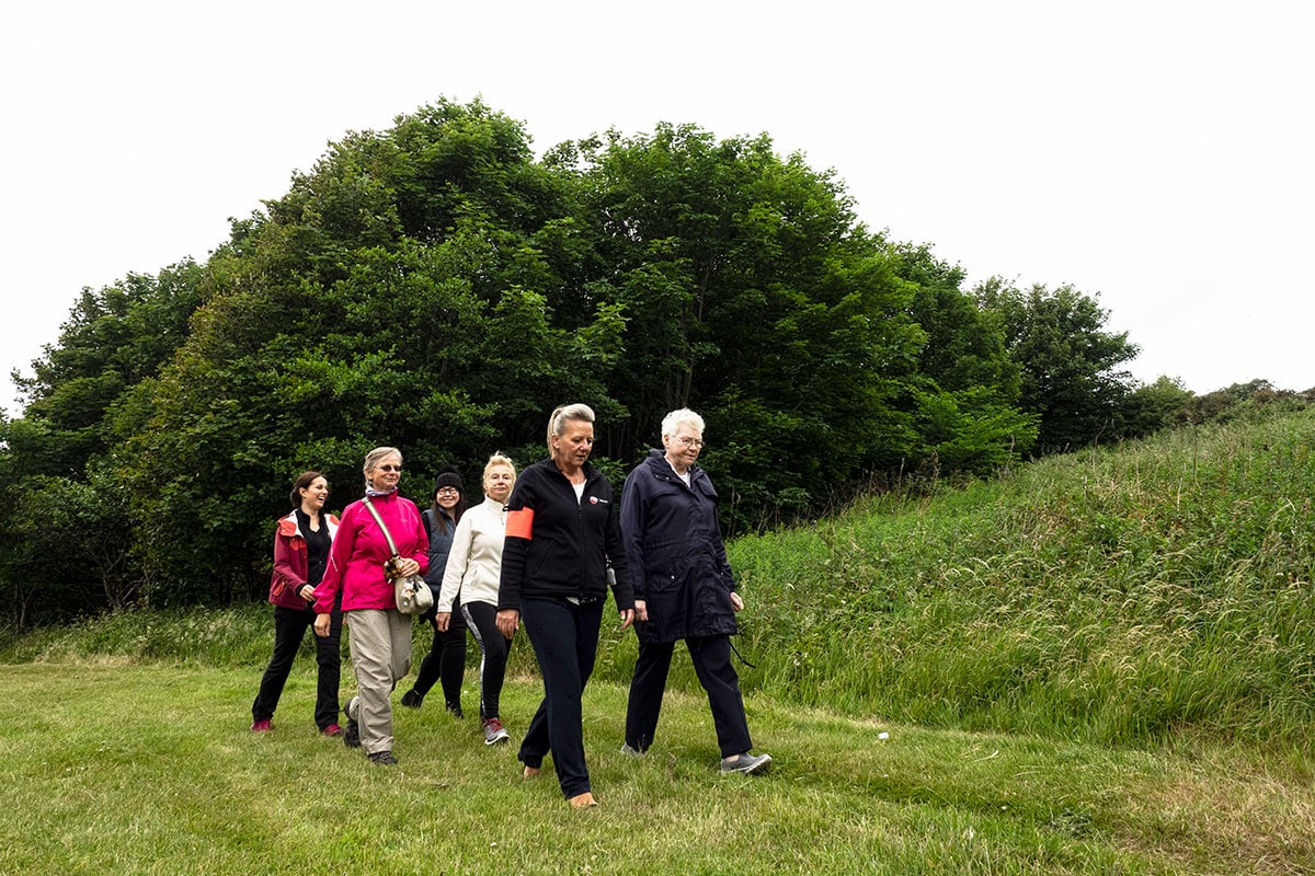 Volunteer walk leader guiding a group of women on a walk