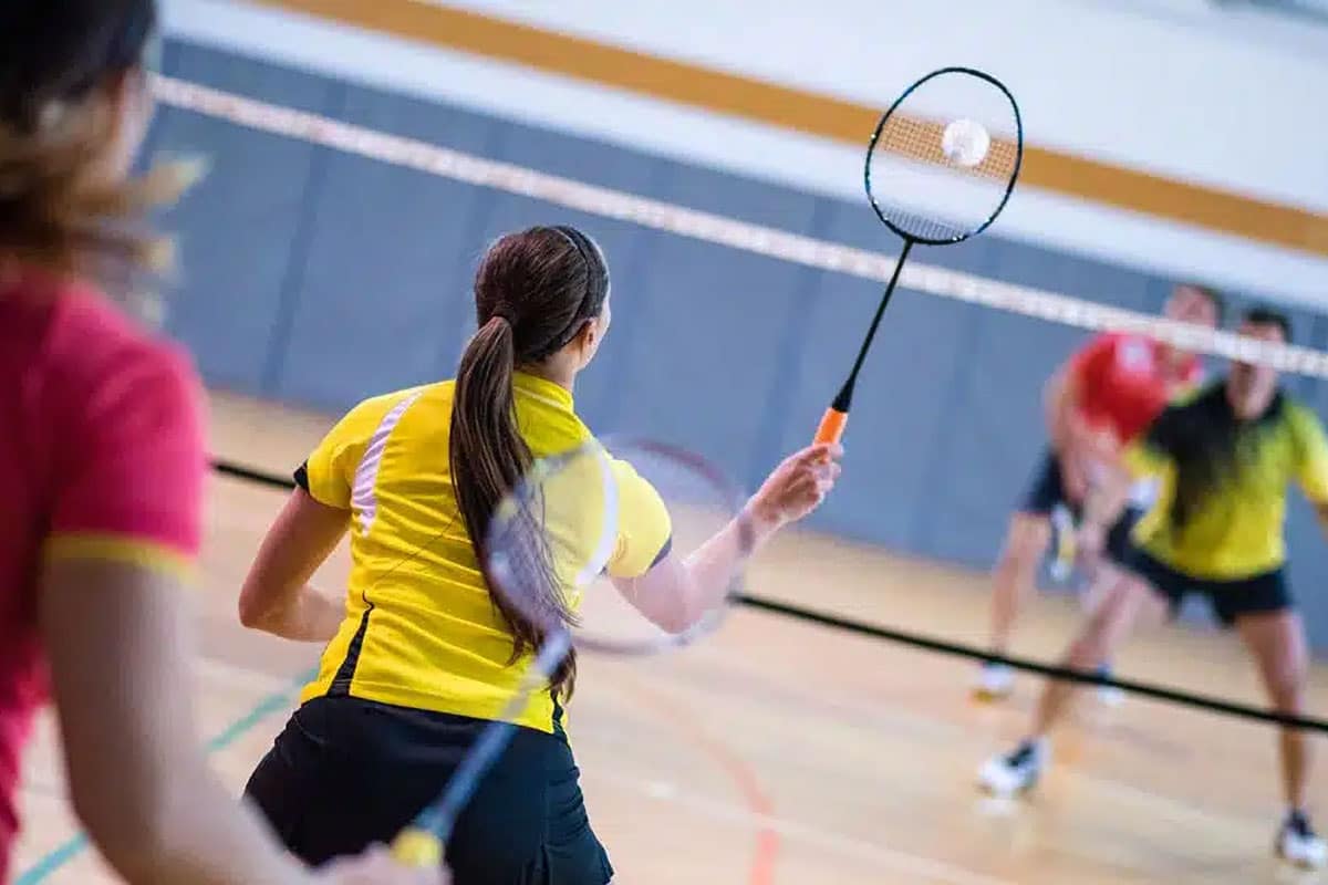 Adults playing badminton