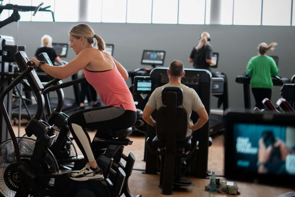 Group of people exercising on gym equipment