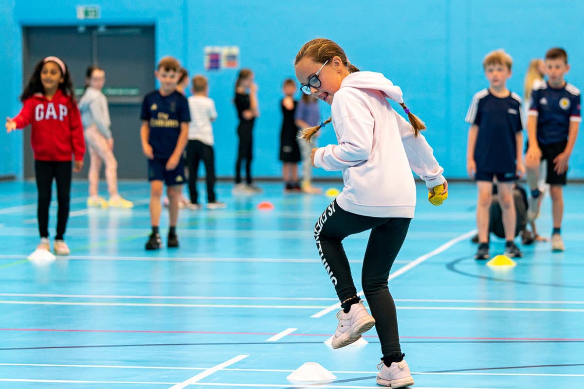 Kids teams competing in sports hall