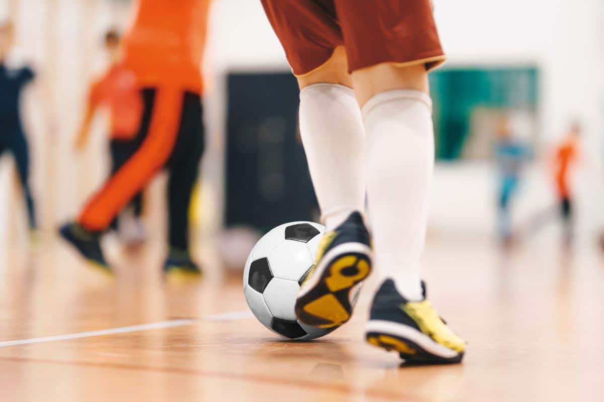 Boy kicking football