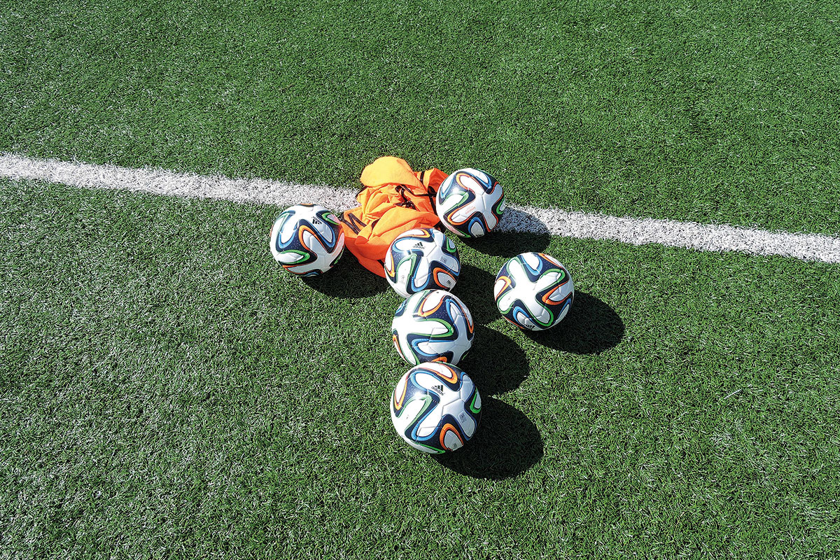 Footballs on pitch