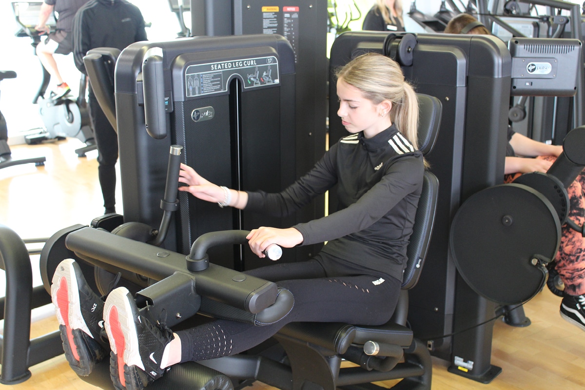 Teenage girl using gym equipment