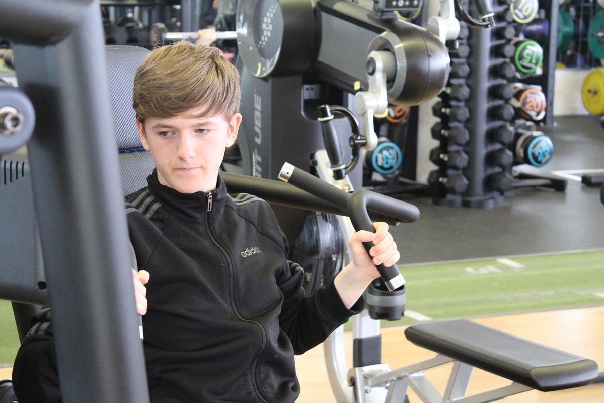 Teenager using gym equipment