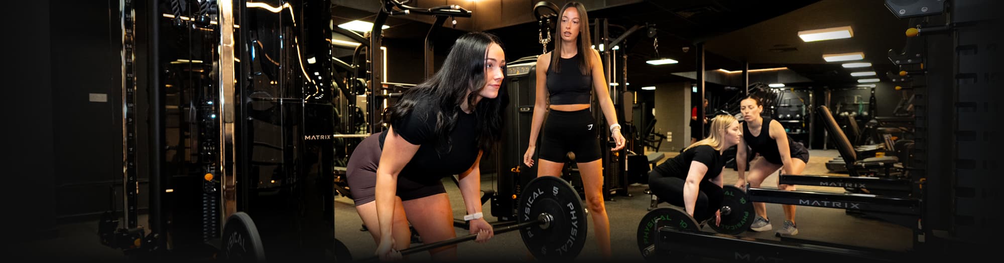 Girls lifting weights in Auchenharvie gym